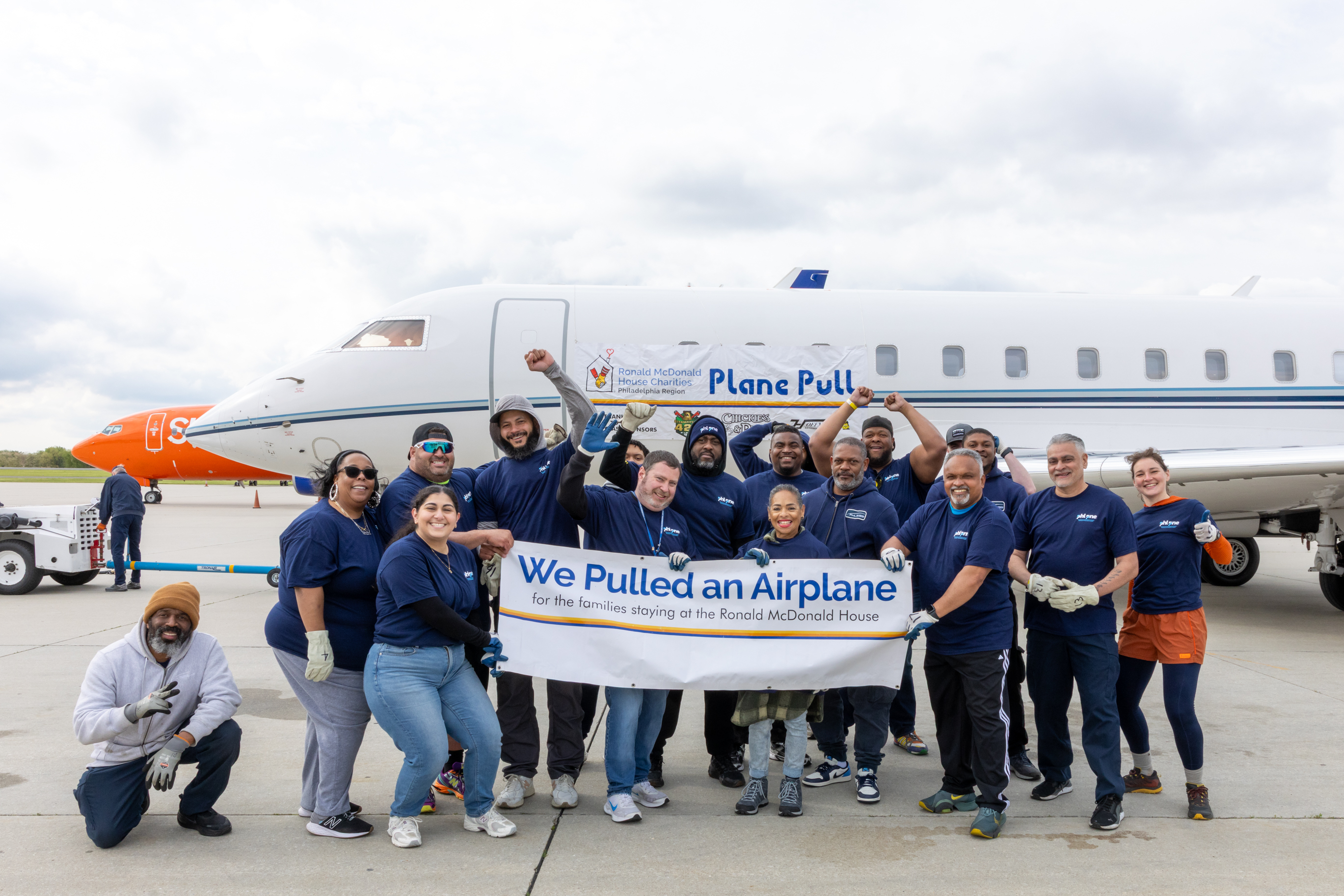 PHL Employees holding plane pull sign