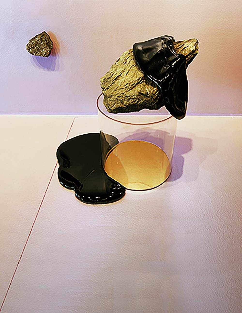 black glass slabs draped on the walls and floors of an exhibition case