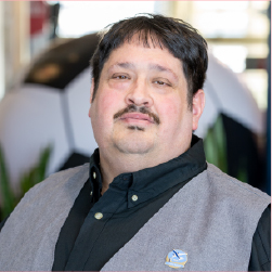 Ayal headshot, short dark hair, mustache, grey vest with black shirt
