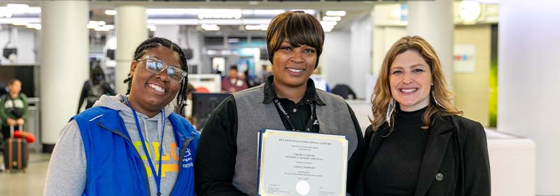 Chimeye holding award while with her colleagues