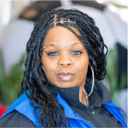Robin's headshot, wearing braids and blue vest