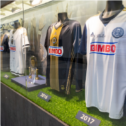 a glass display with Philadelphia union jerseys through out the years. shown are the jerseys from 2015-2017